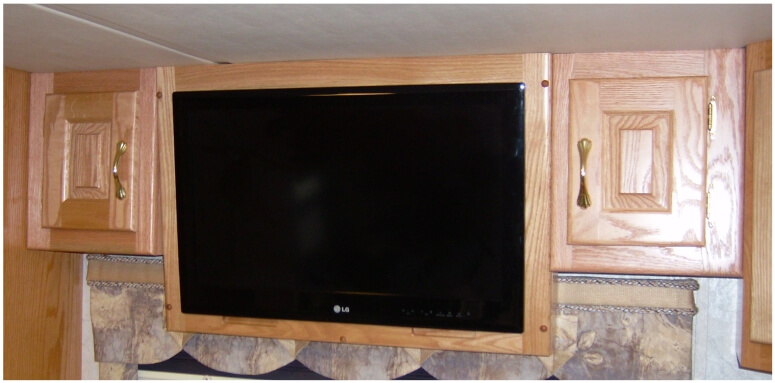 Custom RV bedroom TV cabinet mounted